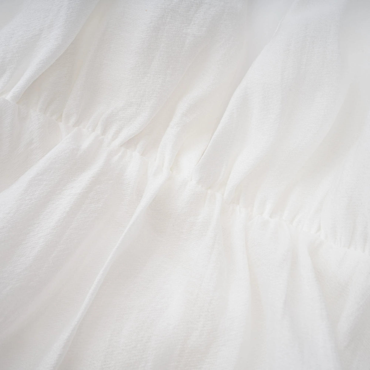 Quincie white shirred flounced mini dress