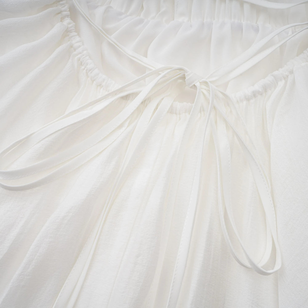 Quincie white shirred flounced mini dress